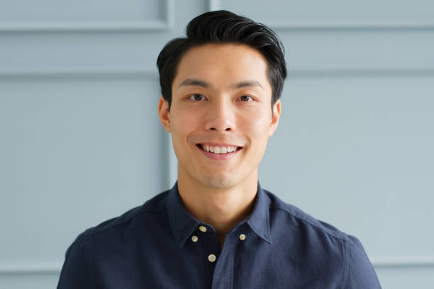 Portrait young confident smart Asian businessman look at camera and smile
